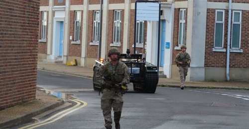 British soldiers and an UGV-mounted sensor taking part in this year's CUE21 experiment in Portmouth, Hampshire. The experiment used new technology to address the complexities of developing situational awareness in an urban environment.