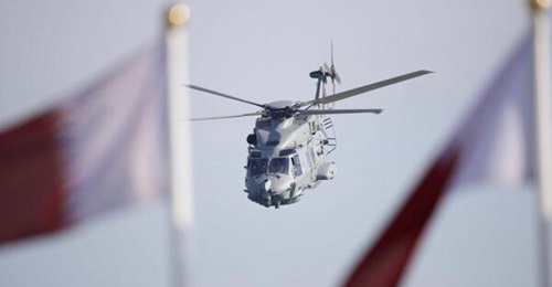 Qatar's recently delivered NH90 NFH helicopter salutes the VIP stand during the National Day parade.