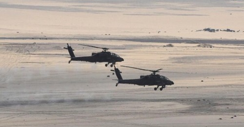 Two Egyptian Air Force AH-64D Apache attack helicopters are seen in a photograph released by the Egyptian Ministry of Defense in February 2018. The country is to upgrade its fleet of 43 such helicopters to the latest AH-64E standard.