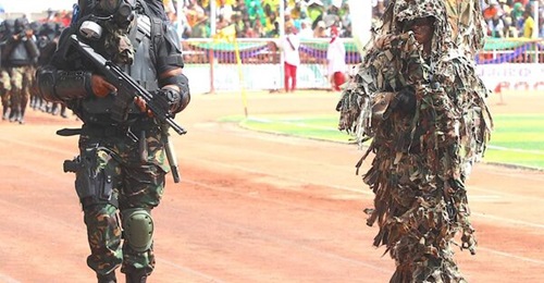 A Tanzanian special forces soldier (left) carries a Gilboa DBR Snake assault rifle during the 12 January parade.