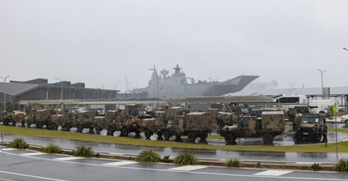 Australian Army's Mercedes-Benz G-Wagon vehicles are parked at the Port of Brisbane, ready to be loaded onto HMAS 
        
        before departure on Operation 'Tonga Assist 2022'.