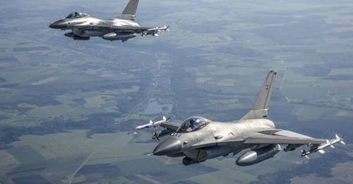 Two of the F-16s that Denmark is contributing to NATO's enhanced air policing mission.