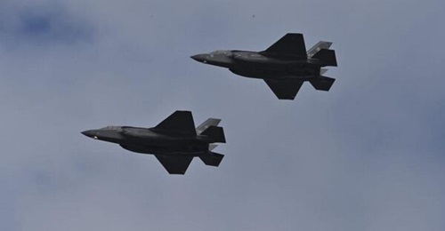An air force and a navy aircraft flying together during a combined exercise that was geared at integrating Italy's F-35B assets into a joint force.