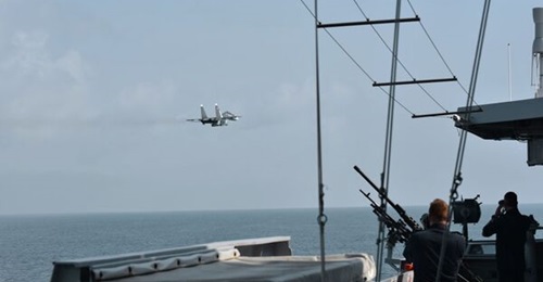 Russian Su-30SM multirole fighter carrying what appears to be a Kh-31 anti-ship missile flying by the RNLN LCF frigate 
        
         in the Black Sea on 24 June.