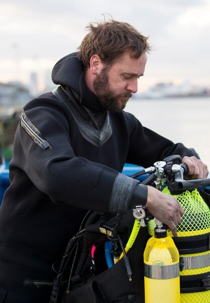 A UK Royal Navy diver prepares to remove a Second World War explosive device found in the River Thames. The RN is reorientating and rebrigading its Fleet Diving Squadron into a new Diving and Threat Exploitation Group.