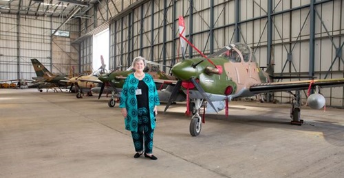 US Ambassador to Nigeria Mary Beth Leonard stands in front of three A-29 Super Tucano light attack aircraft in the hangar at Kainji Air Base during the ground-breaking ceremony on 15 February.