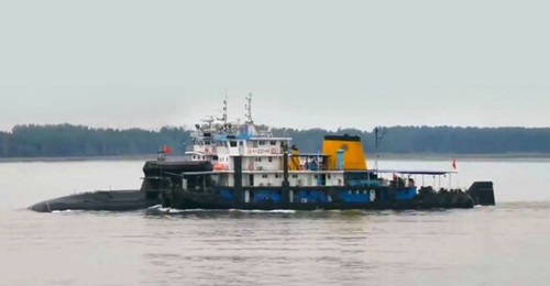 A composite image produced from multiple screengrabs taken from video footage posted on the TikTok social media platform around mid-June showing what appears to be a new conventionally powered submarine for the Chinese navy. The boat is fitted with a r...