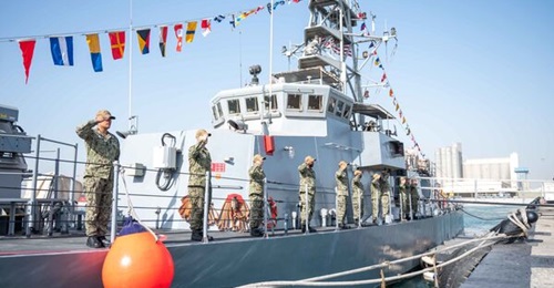 USS 
        
        's crew salute during the ship's decommissioning ceremony at Naval Support Activity Bahrain on 23 February. 
        
        was assigned to the US 5th Fleet in 2003.