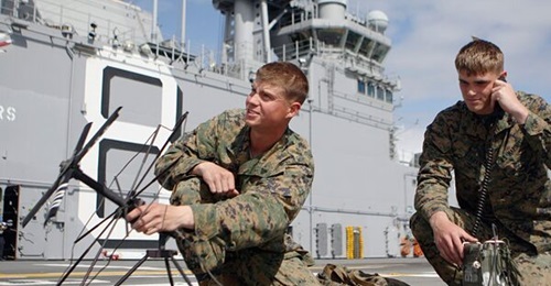 US Marines with 1st Tank Battalion perform radio checks on a Harris 117 radio in preparation of exercises aboard USS 
        
        .