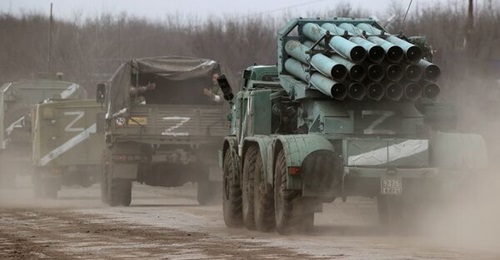 A column of Russian military vehicles leaves the town of Armyansk, northern Crimea, on 24 February. Spray-painted markings have been widely observed on vehicles.