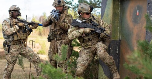 Ukrainian Special Operations Forces and US Army Special Forces soldiers assigned to 10th Special Forces Group (Airborne) enter an enemy-occupied building during Exercise 'Combined Resolve XI' at the Joint Multinational Readiness Center in Hohenfels, Ge...