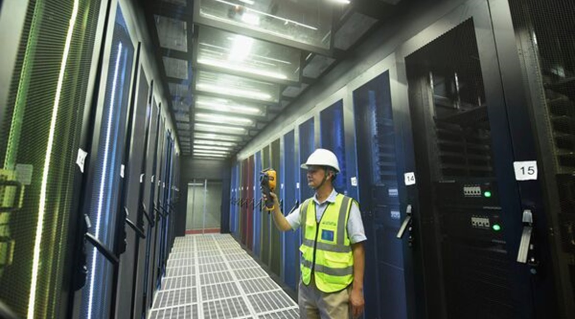 An employee monitors computer server racks at a cloud computing data centre in Hangzhou, China.