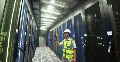An employee monitors computer server racks at a cloud computing data centre in Hangzhou, China.