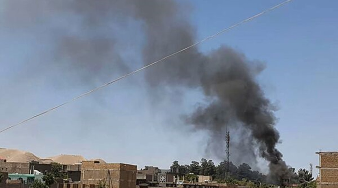 A smoke plume rises from houses in the city of Qala-i-Naw, the capital of Afghanistan's northwestern Badghis Province, amid fighting between ANDSF troops and the Taliban on 7 July.