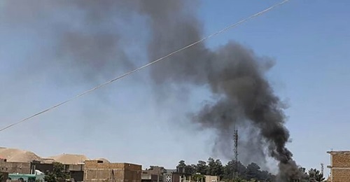 A smoke plume rises from houses in the city of Qala-i-Naw, the capital of Afghanistan's northwestern Badghis Province, amid fighting between ANDSF troops and the Taliban on 7 July.