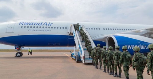 Rwandan troops embark on an airliner destined for Mozambique at Kigali International Airport on 10 July.