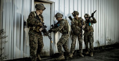 USMC personnel conduct military operations in urban terrain training equipped with the latest version of Saab's GAMER tactical engagement simulation system equipment, the same is being supplied under the FoFTS-Next contract. Note the sensor over the do...