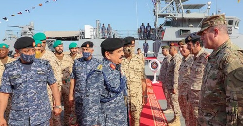 Bahrain's King Hamad greets officers in front of RBNS 
        
        , one of the five Cyclone-class patrol ships he commissioned on 30 March.