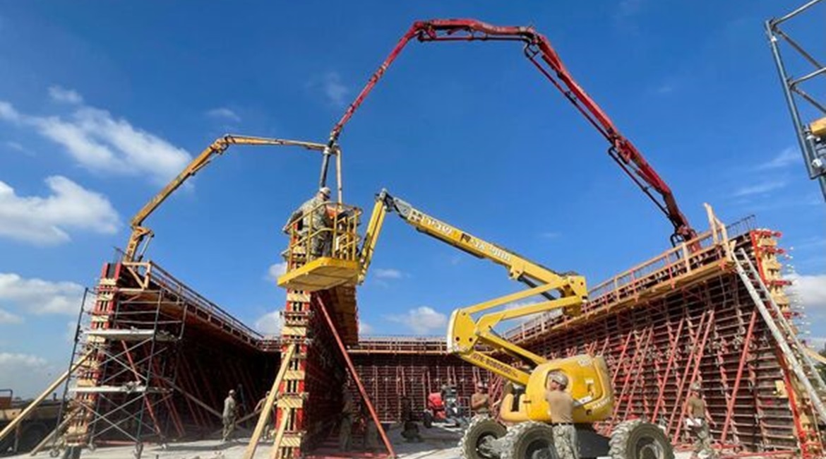 A detachment from US Naval Mobile Construction Battalion 11 pours concrete for the walls of a new building at Hatzor Air Base.