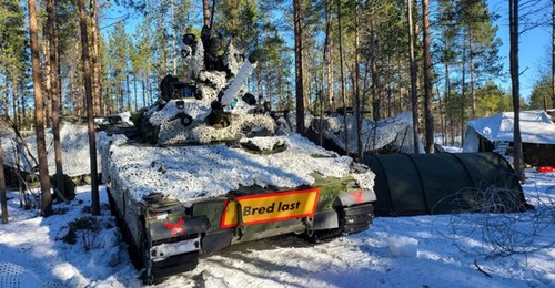 Norwegian Army units, including a CV90 infantry fighting vehicle, await the second phase of the Norwegian/Swedish-Finnish brigades' defensive operation during Exercise 'Cold Response', near Bardufoss, northern Norway.
