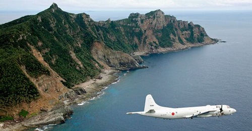 A Japanese P-3C Orion surveillance plane flies over the main island of the disputed Senkaku-Diaoyu archipelago. The uninhabited islands have become a focal point for Japan-China military flights.