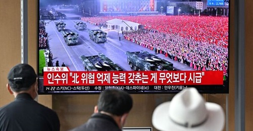 People at a railway station in Seoul watch a news broadcast of a military parade held in Pyongyang to commemorate the 90th anniversary of the founding of the KPA on 25 April 2022.