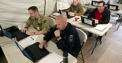 US and partner country military personnel participate in an MPE computer network demonstration in Suffolk, Virginia, on 4 November 2021.