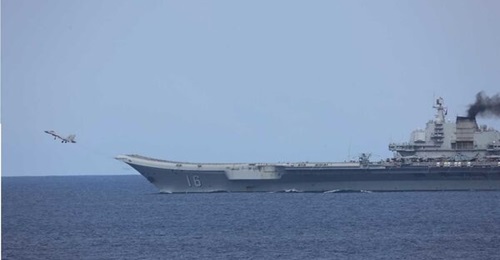 A PLAN J-15 fighter aircraft takes off from China's 
        
         aircraft carrier in the East China Sea in May 2022. CAIG Z-18 ASW helicopters can also been seen on the deck of the carrier.