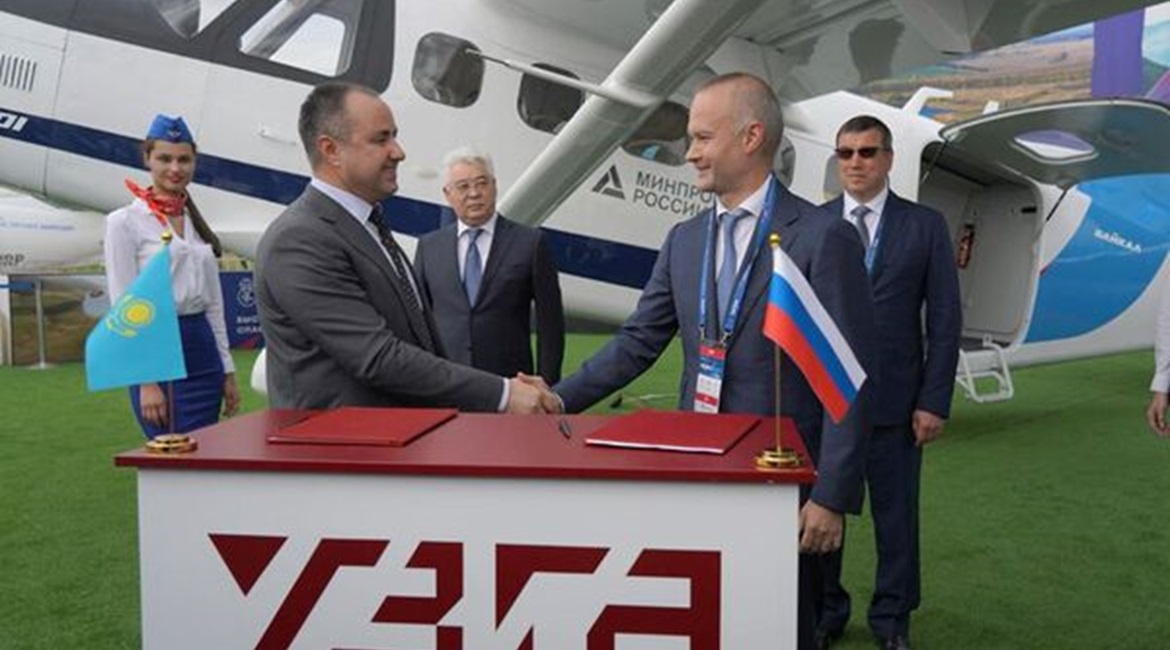 Kazakhstan Aerospace Industries' Daniyar Amangildin (l) and Ural Civil Aviation Works' Vadim Badekha (r) at the signing of KAI's acquisition of a 20% stake in Baikal-Engineering by KAI at the MAKS 2021 Air Show in Moscow, Russia.