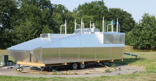 Plath's metallic mock up resembling a Boxer armored personnel carrier (APC), used to illustrate the cylindrical COMINT payload's integration on board a generic ground combat vehicle.