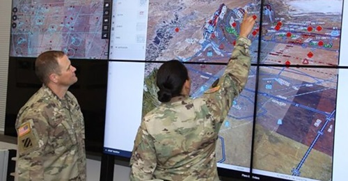 US soldiers observe a demonstration of the Command Post Computing Environment Tactical Service Infrastructure at Aberdeen Proving Ground in Maryland.