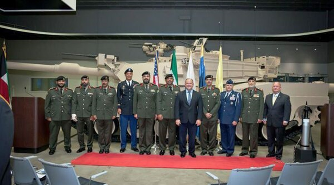 Kuwaiti officers pose with a M1A2K tank.