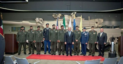 Kuwaiti officers pose with a M1A2K tank.