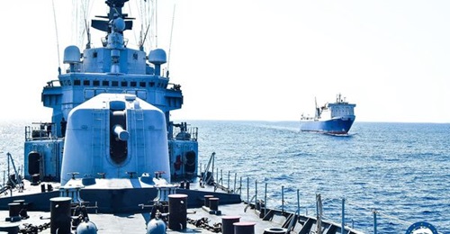 The Italian frigate 
        
         (foreground) found military vehicles destined for Libya on 
        
         (background).