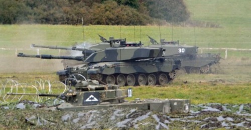 The 28 July Defence Committee report expresses concerns about cuts in British Army Challenger 2 tanks (background) and Warrior infantry fighting vehicles (hull down in foreground).