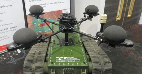 A Microflown Avisa Castle acoustic subarray mounted on an unmanned ground vehicle, displayed at the Omega Future Indirect Fires conference. The acoustic master is located in the centre and the meteorological station is mounted on a short mast next to t...