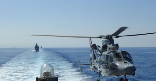 An Indonesian Navy AS565 helicopter hovers over the Turkish corvette 
        
         as other vessels serving with the UNIFIL Maritime Task Force follow behind during an exercise on 28 July.