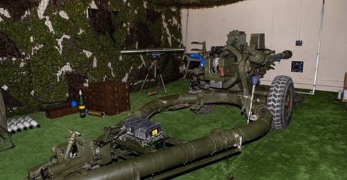 Cubic's artillery mission training system (AMTS) installed on a 105 mm L118 Light Gun at the Royal School of Artillery, Larkhill. The visible appliqué elements (to the left of the breech and under the barrel) are bright blue.