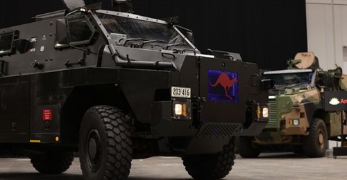 Australia's new Bushmaster ePMV is pictured above after being unveiled at the Chief of Army Symposium 2022 in Adelaide. In the background is a Bushmaster ePMV fitted with ruggedised solar panels.