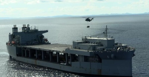 A US Marine CH-53E Super Stallion carries a Joint Light Tactical Vehicle to USS 
        
        (ESB 5) in the Philippine Sea.