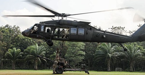 A US Army M119 105 mm howitzer being prepared for transportation by a UH-60 Black Hawk helicopter as an underslung load at exercise 'Super Garuda Shield 2022'.