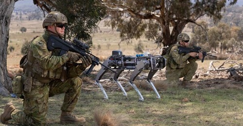 A Ghost Robotics unmanned ground vehicle supports Australian Army soldiers conducting an enemy position clearance during an autonomous systems display at the Majura Training Area, Canberra. The army is promoting the further development of such systems ...