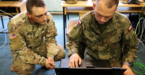 A US Army soldier and a Polish army officer establish an expeditionary network during exercise 'Saber Strike' at Drawsko Pomorskie Training Area, Poland.