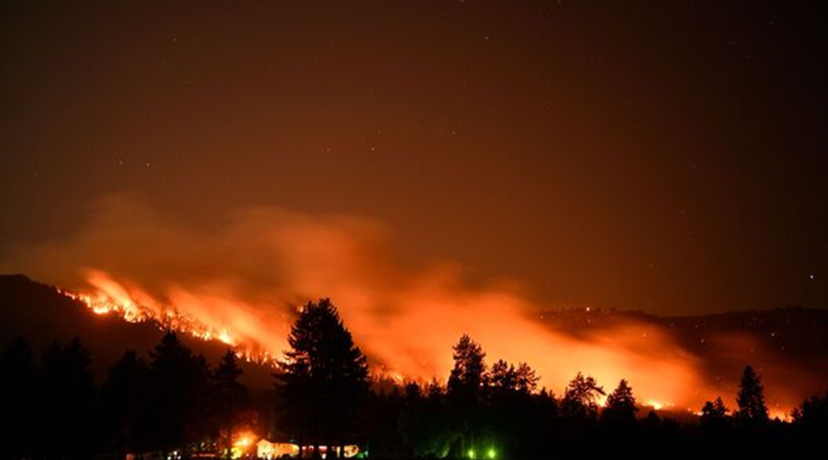 Trees burn on a hillside behind Honey Lake campground during the Dixie wildfire on 18 August 2021 in Milford, California. The wildfire had burnt more than 626,000 acres of land.