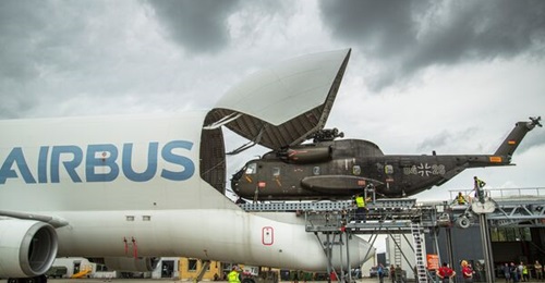 Airbus loads a CH-53 helicopter onto the BelugaST as it looks to develop the outsized airlifter for military use.