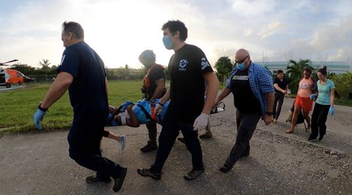 US Coast Guard Air Station Clearwater helicopter crew members assist a critically injured Haitian citizen on 18 August.