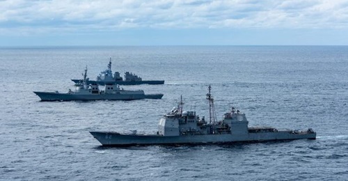 The Ticonderoga-class cruiser USS 
        
         (foreground) along with the JMSDF destroyer JS 
        
         (background) and Republic of Korea Navy guided-missile destroyer ROKS 
        
         conduct a trilateral ballistic miss...