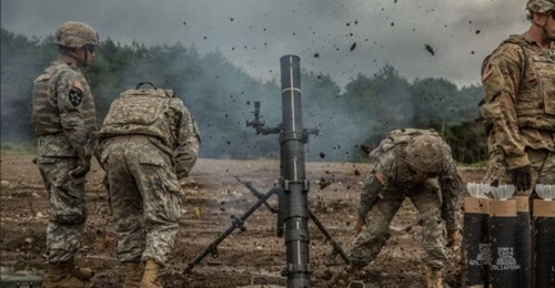 Soldiers practice firing an M120 120 mm mortar.