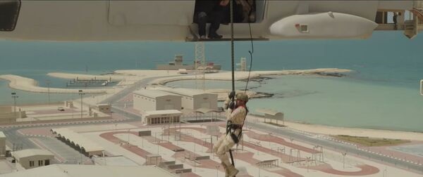 A still from the video released by the Qatari MoD shows a soldier rappelling from a tower with a simulated NH90 helicopter at the new special forces training centre. The simulated ship can be seen in the background.