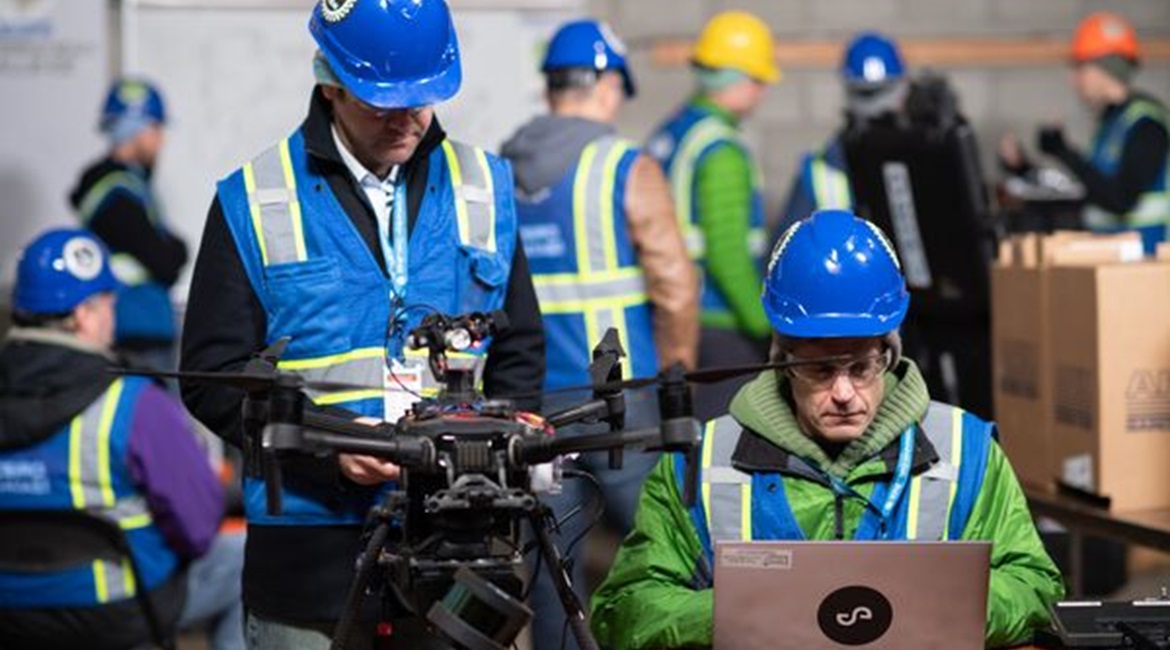 Team CSIRO Data61's DJI Matrice 210 UAV developed by Emesent in an undated image from DARPA's SubT Challenge urban circuit. The aircraft includes a Hovermap payload developed to include a light detection and ranging (LIDAR) sensor that helps the team m...